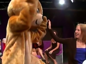 A dude is dancing for some women in his bear costume. The girls rip if off...