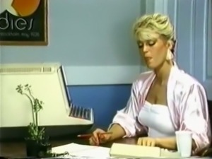Wicked and hot blonde woman in the office teases her colleague