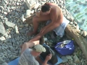 Two men got busy with fucking holes of lusty brunette bitch on beach