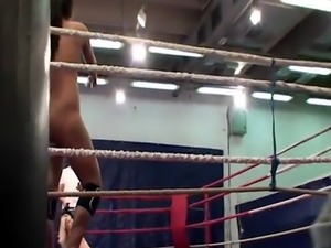 Athletic lesbians wrestling in a boxing ring