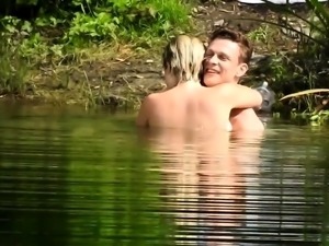 Passionate young lovers engage in hot sex action in the lake