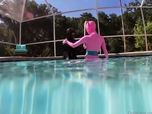Amateur lesbian freaks in latex having fun in the pool