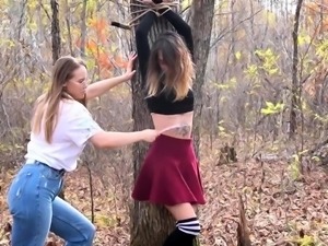 Bound and gagged girl tickled by lesbian femdom in the woods