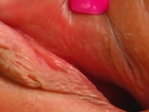 A Spicy black haired oils up and opens her pink pussy lips. She inserts some...