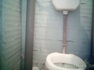 White brunette lady in the public toilet room pisses and wipes her pussy