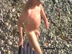 This amateur whore is having sex with some lucky old fart on the beach
