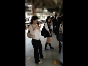 Attractive Japanese schoolgirl in uniform upskirt in public 