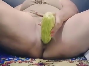 BBW stuffs her pussy with a large cucumber