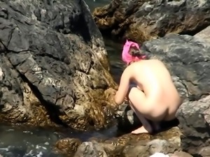 Beach voyeur finds a lovely amateur babe enjoying the sun