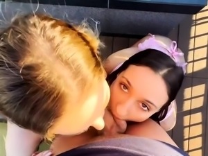 Beautiful young babes teaming up on a big cock outside
